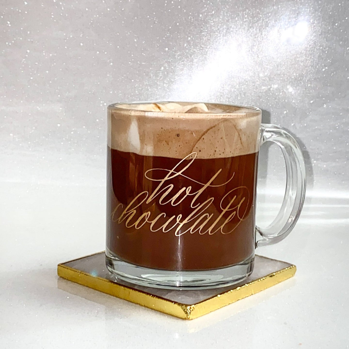 Gold hot chocolate calligraphy glass mug on a pink and gold coaster